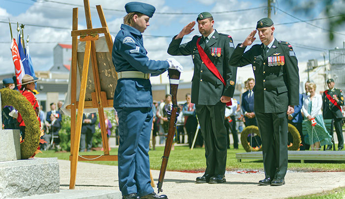 Master Warrant Officer Matthew Shaw (left) and Major Colin Carswell salute after laying a wreath on behalf of 2PPCLI.<br />